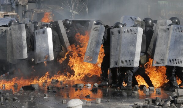 FILE - In this file photo taken on Feb. 18, 2014, riot police clash with anti-government protesters outside Ukraine's parliament in Kyiv, Ukraine. On Nov. 21, 2023, Ukraine marks the 10th anniversary of the uprising that eventually led to the ouster of the country’s Moscow-friendly president. (AP Photo/Efrem Lukatsky, file)