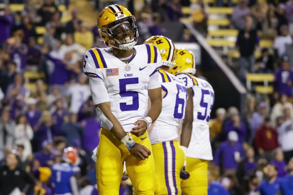 LSU quarterback Jayden Daniels (5) smiles after a touchdown against Florida during the second half of an NCAA college football game in Baton Rouge, La., Saturday, Nov. 11, 2023. (AP Photo/Derick Hingle)