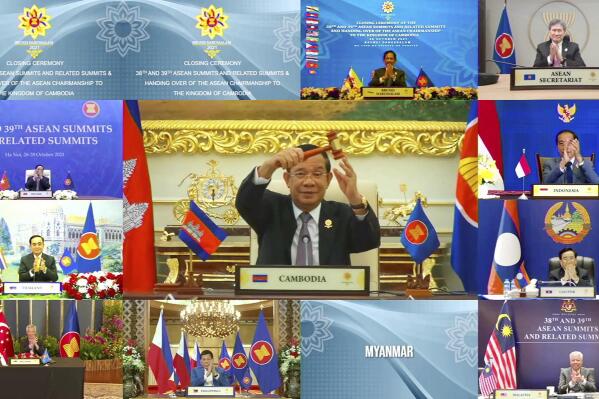 This handout photo released by Brunei ASEAN Summit on Thursday, Oct. 28, 2021, shows Cambodian Prime Minister Hun Sen, center, holding up the gavel for ASEAN chairmanship during the online closing ceremony of the 2021 Association of Southeast Asian Nations (ASEAN) summit, on a live video conference in Brunei's capital Bandar Seri Begawan, Wednesday, Oct. 27, 2021. Southeast Asian leaders began their annual summit without Myanmar on Tuesday amid a diplomatic standoff over the exclusion of the leader of the military-ruled nation from the group's meetings. An empty box of Myanmar is seen at bottom second from right. (Brunei ASEAN Summit via AP)