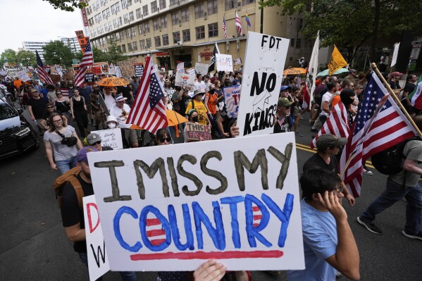 Demonstrators march during a protest taking place on the day of a military parade commemorating the Army's 250th anniversary, coinciding with President Donald Trump's 79th birthday, Saturday, June 14, 2025, in Washington. (AP Photo/Alex Brandon)