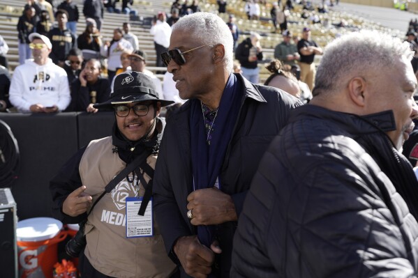 Basketball Hall of Famer Julius Erving looks on as players warm up before an NCAA college football game between Arizona and Colorado, Saturday, Nov. 11, 2023, in Boulder, Colo. (AP Photo/David Zalubowski)