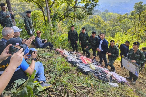 In this photo released by the Office of the Narcotics Control Board on Sunday, Dec. 17, 2023, acting secretary-general of the Office of the Narcotics Control Board Phanurat Lukboon, third right, talks to reporters as bags containing methamphetamine pills are displayed during a news conference in Chiang Rai province, Thailand. A number of suspected drug smugglers were killed and about 2 million methamphetamine tablets seized in a northern Thai border town near Myanmar after a shootout with Thai soldiers, Thai officials said. (Office Of The Narcotics Control Board via AP)