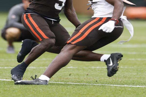 Cleveland Browns wide receiver Jakeem Grant Sr. (9) goes up for a pass against cornerback A.J. Green and is injured on the play during the NFL football team's training camp, Tuesday, Aug. 9, 2022, in Berea, Ohio. (AP Photo/Ron Schwane)