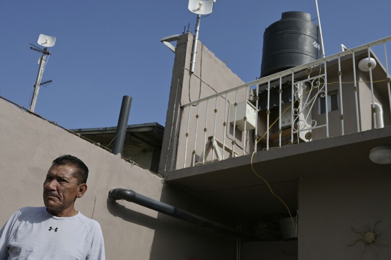 A water storage tank sits atop taxi driver Aurelio Hernández's home in Tijuana, Mexico, Friday, May 12, 2023. Among the last cities downstream to receive water from the shrinking Colorado River, Tijuana is staring down a water crisis. "It is the biggest problem we have," Hernandez said. (AP Photo/Carlos A. Moreno)