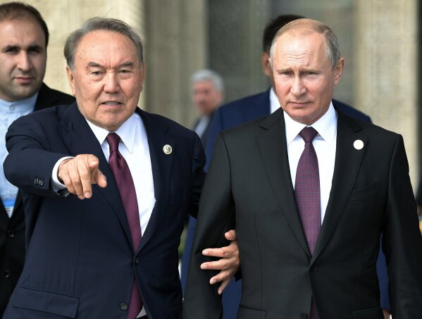
              FILE - In this file photo taken on Aug. 12, 2018, Kazakhstan President Nursultan Nazarbayev, left, gestures as he walks with Russian President Vladimir Putin during the 5th Caspian summit at the Friendship Palace in Aktau, the Caspian Sea port in Kazakhstan. Nazarbayev, who has ruled the oil-rich ex-Soviet nation for nearly three decades, announced his resignation in a televised address to the nation on Tuesday March 19, 2019. (Alexei Nikolsky, Sputnik, Kremlin Pool Photo via AP, File)
            