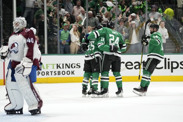 Dallas Stars' Joe Pavelski (16), Roope Hintz (24) and Jamie Benn (14) celebrate a goal by Miro Heiskanen against Colorado Avalanche goaltender Alexandar Georgiev (40) during the first period in Game 2 of an NHL hockey Stanley Cup second-round playoff series in Dallas, Thursday, May 9, 2024. (AP Photo/Tony Gutierrez)