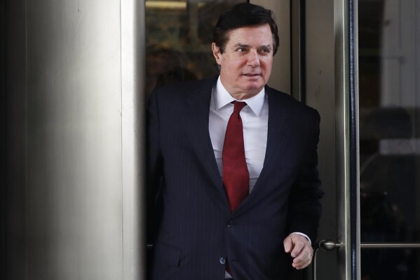 FILE- In this Nov. 6, 2017 file photo, Paul Manafort, President Donald Trump's former campaign chairman, leaves the federal courthouse in Washington. Manafort has been released from federal prison to serve the rest of his sentence in home confinement over concerns about the coronavirus, his lawyer said Wednesday.  (AP Photo/Jacquelyn Martin)