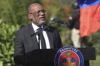 FILE - Haitian Prime Minister Ariel Henry speaks during a ceremony in memory of slain Haitian President Jovenel Moise at the National Pantheon Museum in Port-au-Prince, Haiti, July 7, 2022. Henry has dismissed Haiti’s justice minister, interior minister and its government commissioner in a fresh round of political upheaval, according to documents that The Associated Press obtained on Monday, Nov. 14, 2022. (AP Photo/Odelyn Joseph, File)