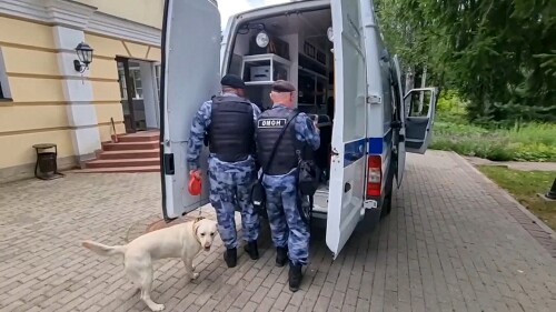 In this photo taken from video released by the National Guard Troops Federal Service of the Russian Federation on Saturday, July 22, 2023, Russian Rosguardia (National Guard) servicemen work near a house where special forces killed a gunman who refused to surrender and fired at them in an elite cottage village in the Istra region, about 45 kilometers, less than 30 miles, west of Moscow, Russia. Russia's National Guard says security forces killed a heavily-armed gunman who broke into a private house in Moscow's suburbs and fired at them, reportedly threatening to march on the Kremlin. (National Guard Troops Federal Service of the Russian Federation via AP)