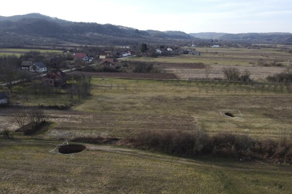 This aerial photo shows sinkholes in the village of Mececani, central Croatia, Thursday, March 4, 2021. A central Croatian region about 40 kilometers (25 miles) southwest of the capital Zagreb is pocked with round holes of all sizes, which appeared after December's 6.4-magnitude quake that killed seven people and caused widespread destruction. Scientists have been flocking to Mecencani and other villages in the sparsely-inhabited region for observation and study. (AP Photo/Darko Bandic)