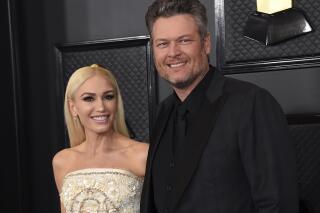 FILE - In this Jan. 26, 2020, file photo, Gwen Stefani, left, and Blake Shelton arrive at the 62nd annual Grammy Awards in Los Angeles. “The Voice” coaches Stefani and Shelton celebrated their nuptials over the Fourth of July holiday during a weekend wedding in Oklahoma. Images were posted Monday, July 5, 2021, of their wedding. (Photo by Jordan Strauss/Invision/AP, File)