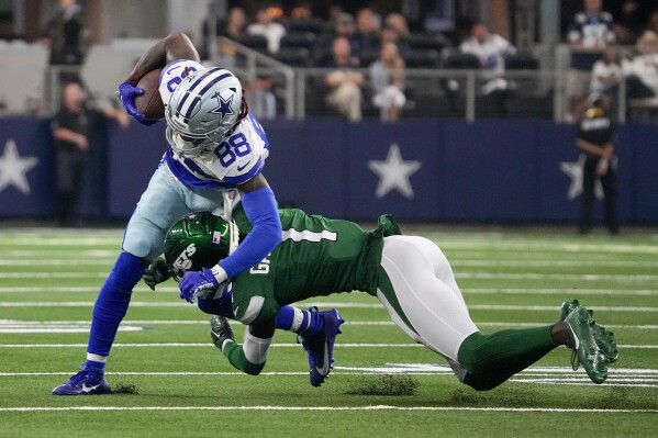 Dallas Cowboys wide receiver CeeDee Lamb is tackled by New York Jets cornerback Sauce Gardner during the second half of an NFL football game in Arlington, Texas, Sunday, Aug. 17, 2023. (AP Photo/Sam Hodde)