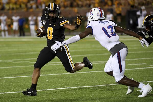 Missouri running back BJ Harris (0) scores on a touchdown run past Louisiana Tech defensive back Myles Brooks (13) during the second half of an NCAA college football game Thursday, Sept. 1, 2022, in Columbia, Mo. Missouri won 52-24. (AP Photo/L.G. Patterson)