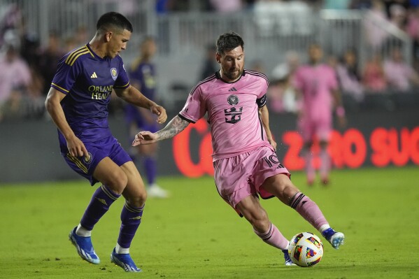 Inter Miami forward Lionel Messi (10) comes under pressure from Orlando City midfielder Cesar Araujo, left, during the second half of an MLS soccer match, Saturday, March 2, 2024, in Fort Lauderdale, Fla. (AP Photo/Rebecca Blackwell)