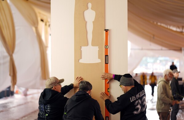 Crew members prepare the red carpet area on Wednesday, March 6, 2024, for Sunday's 96th Academy Awards at the Dolby Theatre in Los Angeles. (AP Photo/Chris Pizzello)