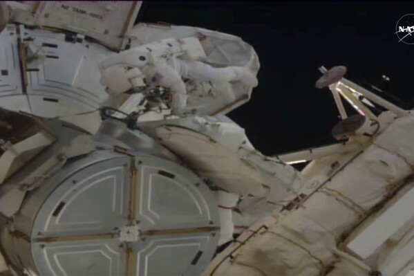 In this image provided by NASA, astronauts Anne McClain and Nichole Ayers work outside the International Space Station during a spacewalk, Thursday, May 1, 2025. (AP Photo/NASA TV)