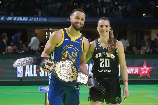 Golden State Warriors guard Stephen Curry and New York Liberty guard Sabrina Ionescu pose for photos following their competition at the NBA basketball All-Star weekend, Saturday, Feb. 17, 2024, in Indianapolis. (APPhoto/Darron Cummings)