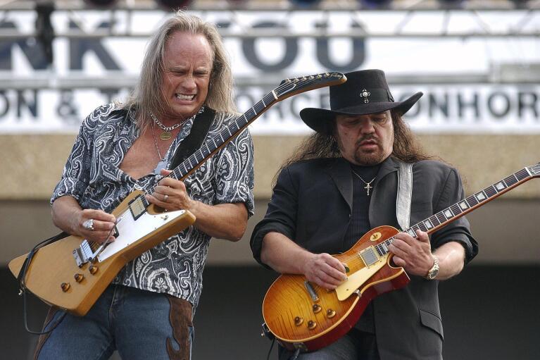 FILE - Rickey Medlocke and Gary Rossington, right, guitarists for Lynard Skynard, tear through a solo during the band's performance at a Welcome Home Celebration for the 4th Infantry Division and Task Force Ironhorse on Thursday, April 22, 2004, at Fort Hood, Texas. Rossington, Lynyrd Skynyrd’s last surviving original member who also helped to found the group, died Sunday, March 5, 2023, at the age of 71. (Steve Traynor/The Killeen Daily Herald via AP)