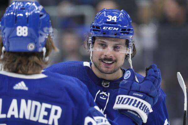 Toronto Maple Leafs center Auston Matthews (34) celebrates with teammate William Nylander (88) after their NHL hockey game against the Detroit Red Wings in Toronto on Tuesday, April 26, 2022. (Frank Gunn/The Canadian Press via AP)