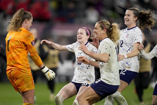 United States goalkeeper Alyssa Naeher, left, celebrates with teammates at the end of the penalty shootout in a CONCACAF Gold Cup women's soccer tournament semifinal match against Canada, Wednesday, March 6, 2024, in San Diego. (AP Photo/Gregory Bull)