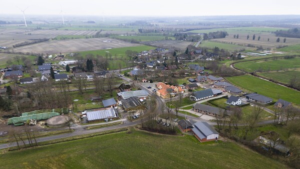 The village Sprakebuell, Germany, is shown in an aerial photo taken Thursday, March 14, 2024. Sprakebuell is something of a model village for the energy transition - with an above-average number of electric cars, a community wind farm and renewable heat from biogas. All houses in the village center have been connected to the local heating network and all old oil heating systems have been removed. (AP Photo/Frank Molter)