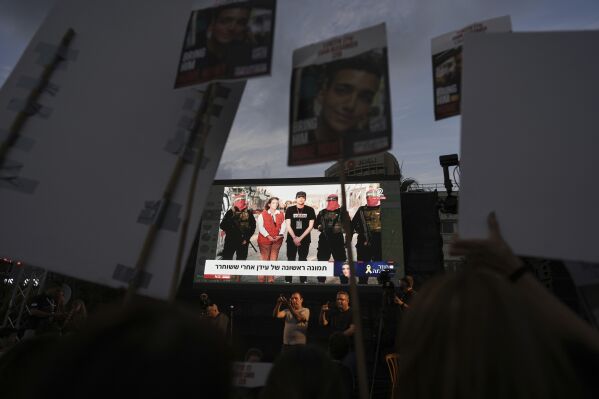 People watch a live broadcast of Israeli-American soldier Edan Alexander as he is released from Hamas captivity in Gaza, at a plaza known as the hostages square in Tel Aviv, Monday, May 12, 2025. Alexander was abducted during the Hamas-led attack on his base on October 7, 2023. (AP Photo/Oded Balilty)