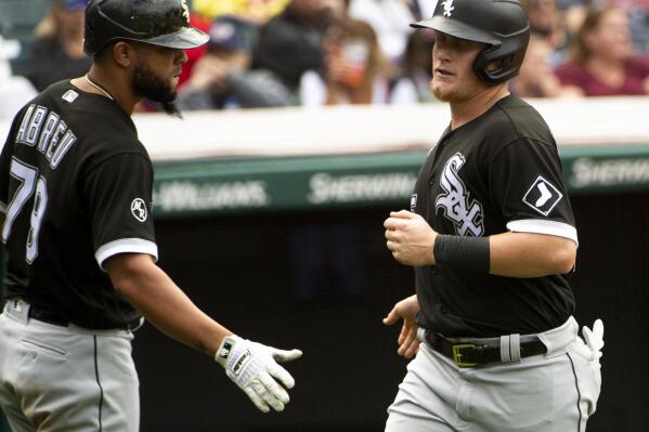 Chicago White Sox's Jose Abreu greets Andrew Vaughn after Vaughn scored on a single by Leury Garcia during the sixth inning of a baseball game in Cleveland, Sunday, Sept. 26, 2021. (AP Photo/Phil Long)