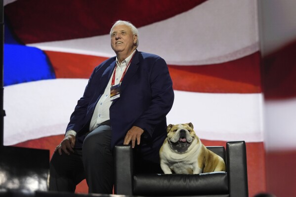 West Virginia Gov. Jim Justice checks out the stage with his dog, "Babydog," before the Republican National Convention Tuesday, July 16, 2024, in Milwaukee. (AP Photo/Jae C. Hong)