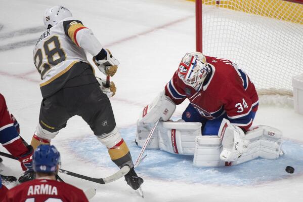 Montreal Canadiens goaltender Jake Allen stops Vegas Golden Knights' William Carrier (28) during the first period of an NHL hockey game Saturday, Nov. 5, 2022, in Montreal. (Graham Hughes/The Canadian Press via AP)