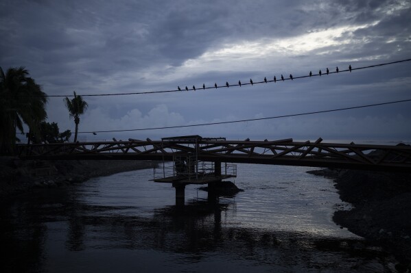 A pedestrian bridge under construction for the Olympic Games is visible in Teahupo'o, Tahiti, French Polynesia, Friday, Jan. 12, 2024. (AP Photo/Daniel Cole)