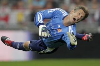 FILE - Former Manchester United goalkeeper Edwin van der Sar watches the ball as he saves on an attempt to score during his farewell tribute match at Amsterdam's ArenA stadium Wednesday Aug. 3, 2011. Edwin van der Sar is stepping down as director general of Ajax after the team finished a disappointing third in the Dutch Eredivisie, missing out on a Champions League berth for next season. (AP Photo/Peter Dejong, File)
