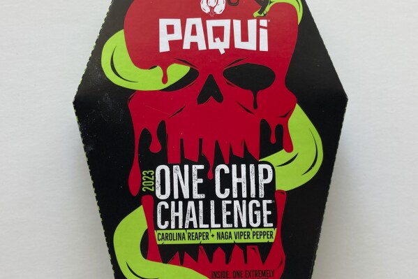 A package of Paqui OneChipChallenge spicy tortilla chips is seen on Thursday, Sept. 7, 2023, in Boston. Authorities are raising the alarm about a OneChipChallenge social media trend that encourages people to avoid seeking relief from eating and drinking for as long as possible after eating the chips, days after a Massachusetts teenager died hours after taking part in the challenge. The dare is popular on social media sites, with scores of people including children unwrapping the packaging, eating the chips and reacting to the heat. (AP Photo/Steve LeBlanc)