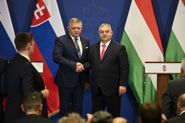 Slovakia's Prime Minister Robert Fico and Hungary's Prime Minister Viktor Orban shake hands after a press conference at the Carmelite Monastery in Budapest, Hungary, Tuesday, Jan. 16, 2024. (AP Photo/Denes Erdos)