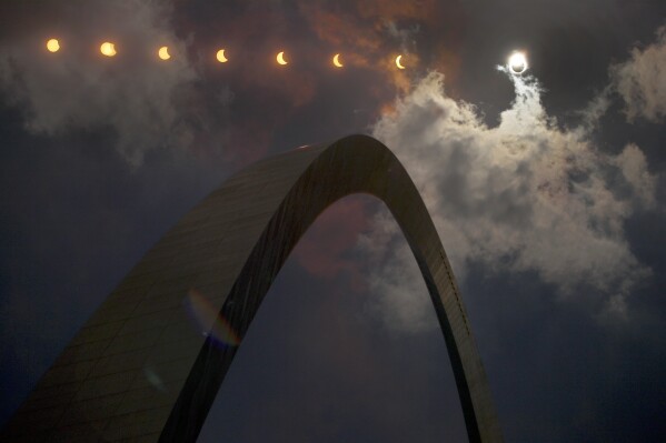 FILE - This multiple exposure photograph shows the progression of a partial solar eclipse over the Gateway Arch in St. Louis on Aug. 21, 2017. (AP Photo/Jeff Roberson, File)