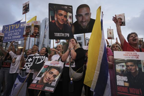 People watch a live broadcast of Israeli-American soldier Edan Alexander as he is released from Hamas captivity in Gaza, at a plaza known as the hostages square in Tel Aviv, Monday, May 12, 2025. Alexander was abducted during the Hamas-led attack on his base on October 7, 2023. (AP Photo/Oded Balilty)