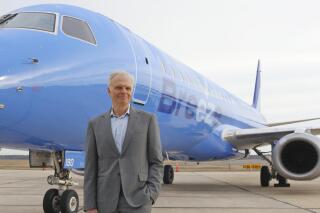 FILE - This file photo provided by CeanOrrett shows David Neeleman with Breeze aircraft.  Breeze Airways said Friday, May 21, 2021,  that it will begin flying May 27 and expand by July to 16 cities, mostly in the Southeast and central U.S. Breeze, the creation of JetBlue Airways founder David Neeleman, is targeting secondary cities that are largely overlooked or abandoned by bigger carriers. Neeleman says 95% of Breeze's early routes have no other nonstop flights. (CeanOrrett via AP, File)