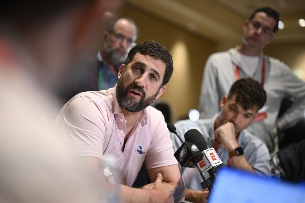 Philadelphia Eagles head football coach Nick Sirianni, center, talks with reporters during an NFC coaches availability at the NFL owners meetings, Tuesday, March 26, 2024, in Orlando, Fla. (AP Photo/Phelan M. Ebenhack)