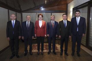From left, Turkey's main opposition Republican People's Party (CHP) leader Kemal Kilicdaroglu, Felicity Party leader Temel Karamollaoglu, Good Party leader Meral Aksener, Future Party leader Ahmet Davutoglu, Democracy and Progress Party leader Ali Babacan and Democrat Party leader Gultekin Uysal pose for photos before their meeting in Ankara, Turkey, late Saturday, Feb. 12, 2022. The leaders of six opposition parties in Turkey met Saturday to strategize about the future of the country's governing system — a move that aims to unseat the country's longtime ruler, President Recep Tayyip Erdogan. (Alp Eren Kaya/CHP via AP)