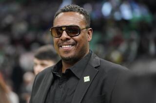 FILE - Former Boston Celtics player Paul Pierce smiles before an NBA basketball game between the Dallas Mavericks and the Boston Celtics, Sunday, March 13, 2022, in Boston. Pierce has agreed to pay about $1.4 million to settle charges that he touted EMAX tokens on social media without disclosing the payment he received for the promotion and for making false and misleading promotional statements about the same crypto asset. The Securities and Exchange Commission announced the settlement Friday, Feb. 17, 2023. (AP Photo/Steven Senne, File)