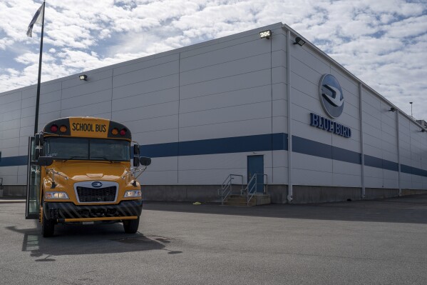 FILE -- An all-electric school bus sits on display in front of the Blue Bird Corp. factory in Fort Valley, Ga., on Feb. 8, 2023. The company and the United Steelworkers union said on Thursday, May, 23, 2024 that workers had approved an initial three-year contract after voting to unionize in May 2023. (Matthew Pearson/WABE via AP, file)