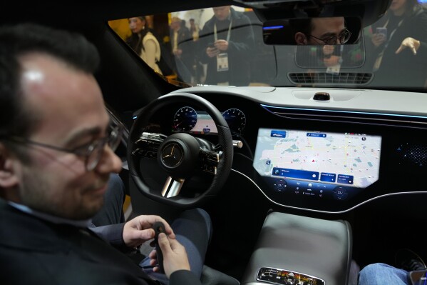 Vadim Weiss, Mercedes-Benz USA, gives a demonstration of the company's car operating system, MBOS, during the CES tech show Tuesday, Jan. 9, 2024, in Las Vegas. (AP Photo/Ryan Sun)
