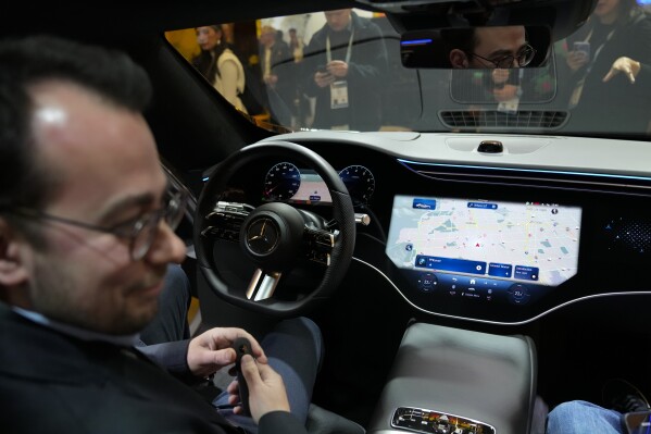 Vadim Weiss, of Mercedes-Benz USA, gives a demonstration of the company's in-car operating system, MBOS, during the CES technology show, Tuesday, Jan. 9, 2024, in Las Vegas.  (AP Photo/Ryan Sun)