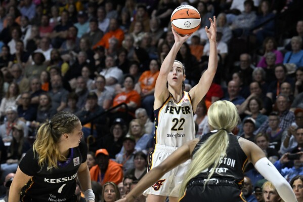 Indiana Fever guard Caitlin Clark (22) puts up a 3-point shot to score against the Connecticut Sun during the fourth quarter of a WNBA basketball game, Tuesday, May 14, 2024, in Uncasville, Conn. (AP Photo/Jessica Hill)