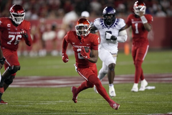 Houston wide receiver Matthew Golden (2) makes a catch and run for a first down against TCU during the first half of an NCAA college football game Saturday, Sept. 16, 2023, in Houston. (AP Photo/David J. Phillip)