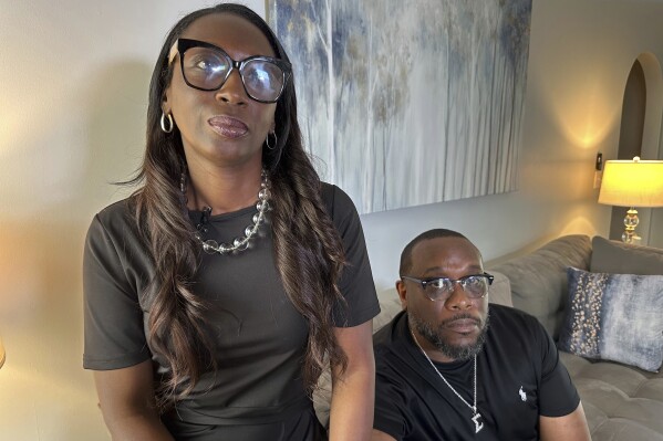 Trina Martin, left, and Toi Cliatt sit for a portrait inside the home the FBI mistakenly raided in 2017, in Atlanta on Friday, April 25, 2025. (AP Photo/Sudhin Thanawala)