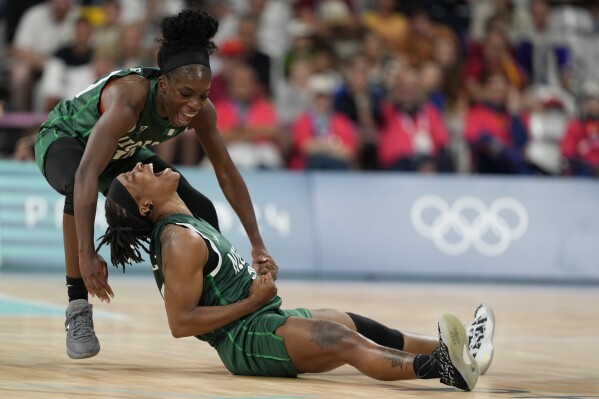 Ezinne Kalu (23), and Promise Amukamara (10), of Nigeria, celebrate in a women's basketball game against Canada at the 2024 Summer Olympics, Sunday, Aug. 4, 2024, in Villeneuve-d'Ascq, France. (AP Photo/Mark J. Terrill)