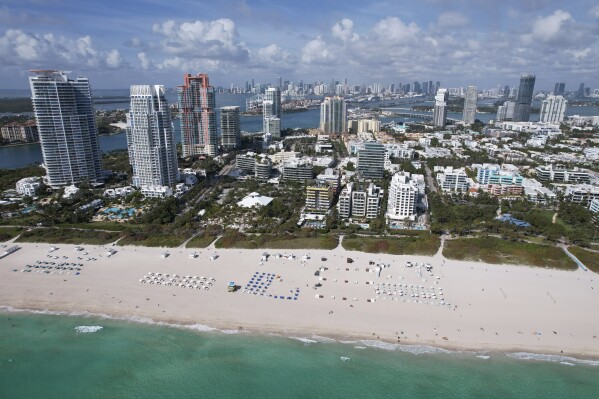 In this photo taken via drone, chairs dot the wide sandy beach, in the South Beach area of Miami Beach, Fla, Thursday, Feb. 29, 2024. Miami Beach is trying to break up with spring break, but it's not yet clear whether spring break will take the hint. (AP Photo/Rebecca Blackwell)