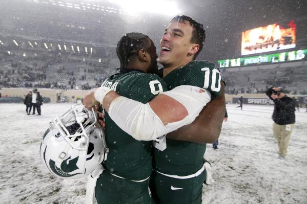 Michigan State quarterback Payton Thorne, right, and running back Kenneth Walker III celebrate following a 30-27 win over Penn State in an NCAA college football game, Saturday, Nov. 27, 2021, in East Lansing, Mich. (AP Photo/Al Goldis)