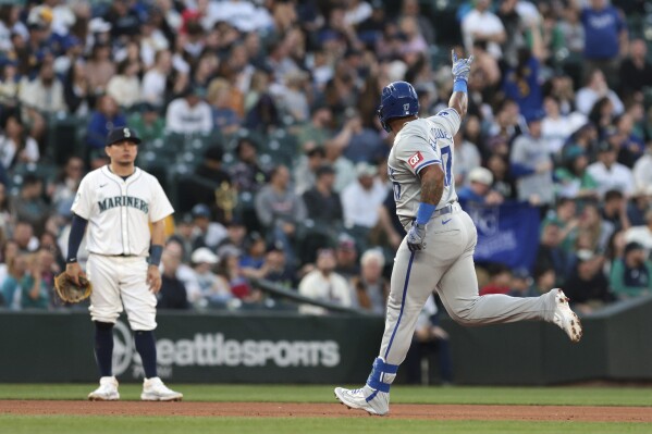 Kansas City Royals' Nelson Velazquez, right, runs the bases after hitting a three-run home run, while Seattle Mariners third baseman Luis Urias watches during the seventh inning of a baseball game Tuesday, May 14, 2024, in Seattle. (AP Photo/Jason Redmond)