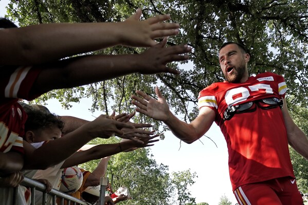 Kansas City Chiefs tight end Travis Kelce greets fans before NFL football training camp Friday, July 28, 2023, in St. Joseph, Mo. (AP Photo/Charlie Riedel)